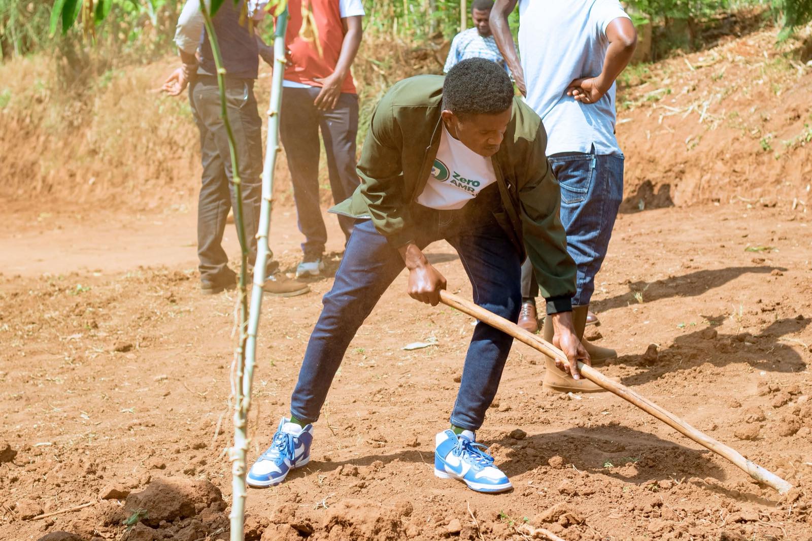 Volunteers in Zero AMR Initiative shirts working alongside community members during a field activity