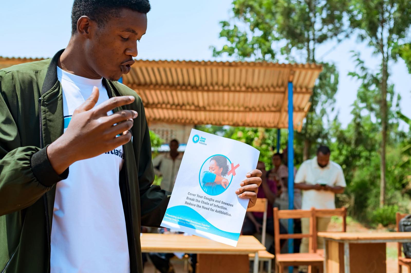 Students reading Zero AMR Initiative educational leaflets about antimicrobial resistance