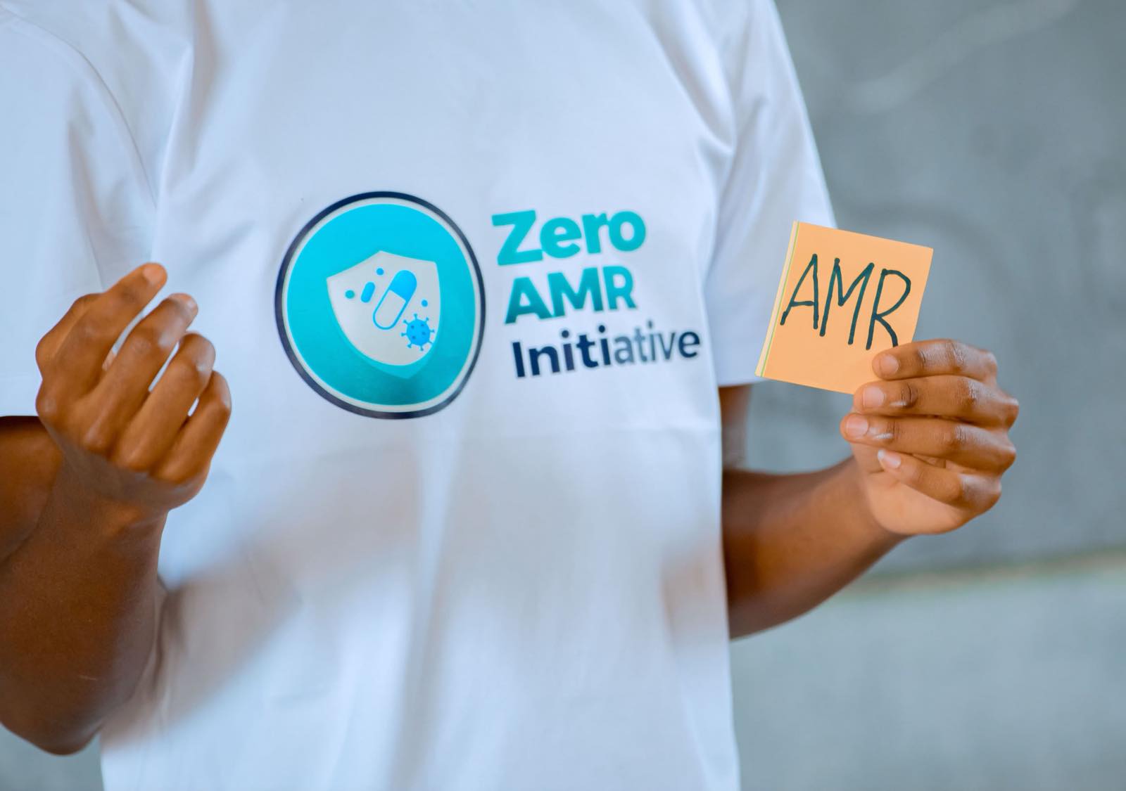 A Zero AMR Initiative volunteer holding up the initiative's logo during a school session